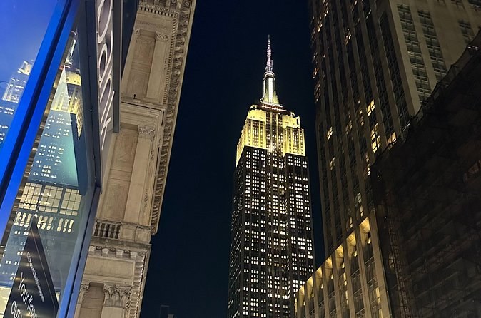 The Art Deco tower on 34th Street seen from the street between buildings at night