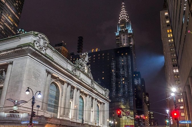 Grand Central Terminal's facade and the Chrysler Building's crown lit at night