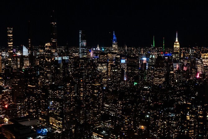 Midtown's towers and the lit avenues from a helicopter at night
